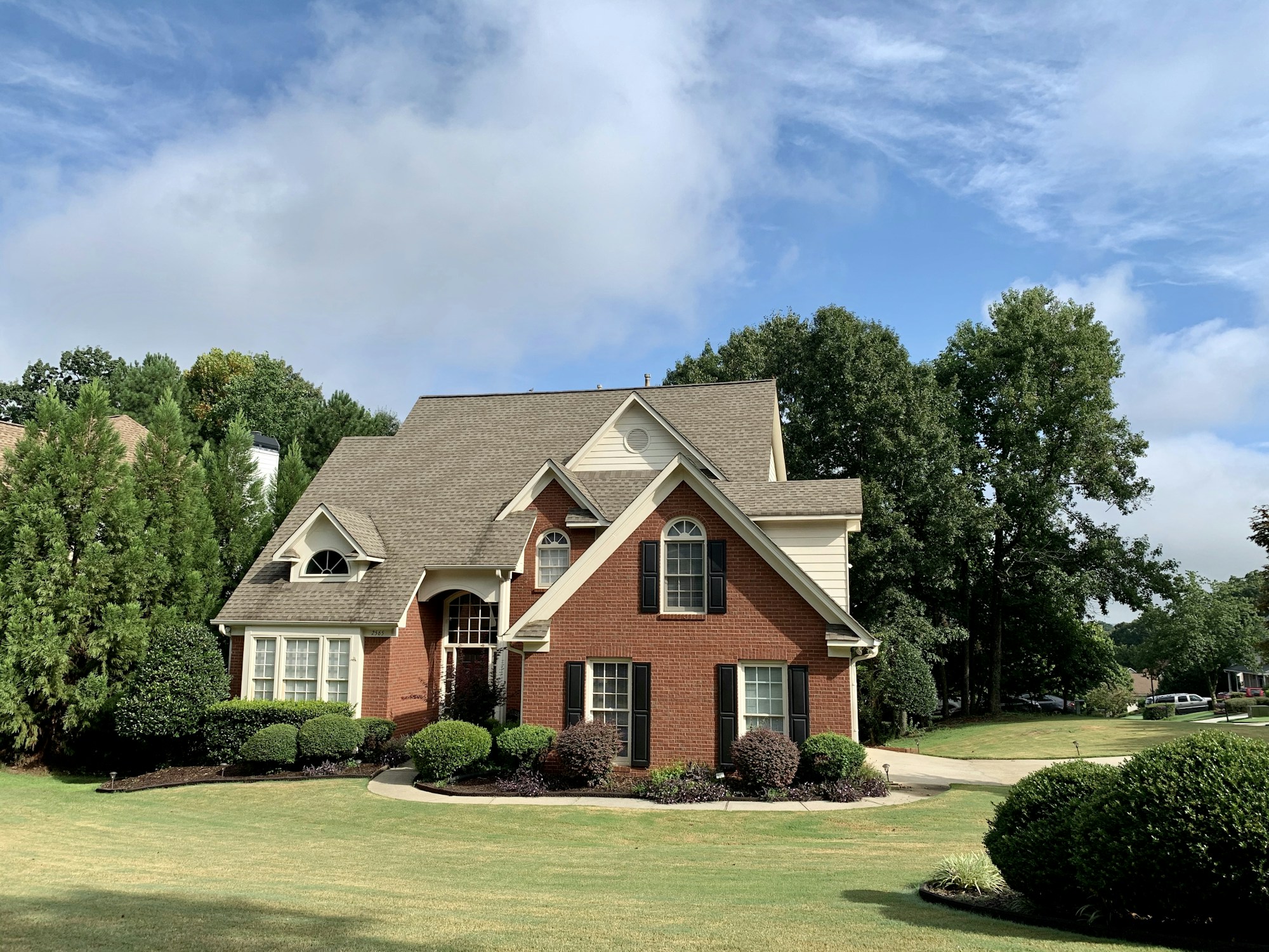 Illustrative home exterior with brickwork, siding and roofing